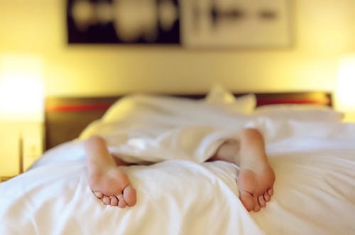 Feet sticking out of bed. Pixabay